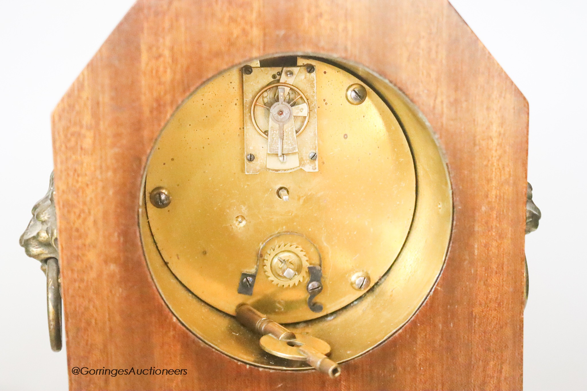 An Edwardian mahogany mantel timepiece, together with a silver plated chamberstick